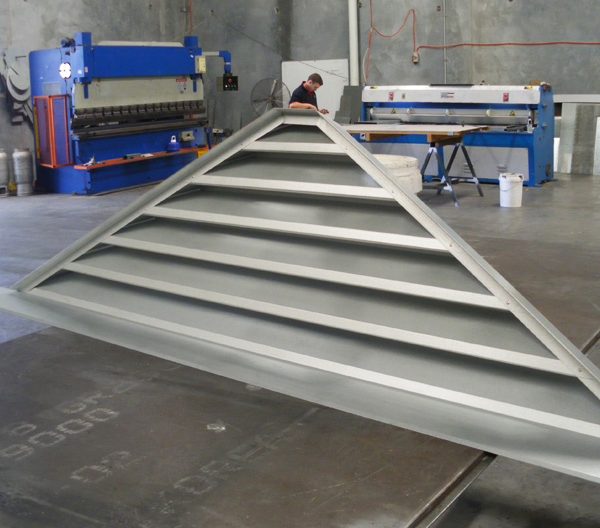 a grey triangle gable louver