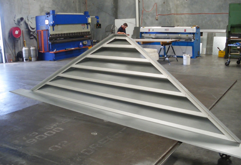 a grey triangle gable louver